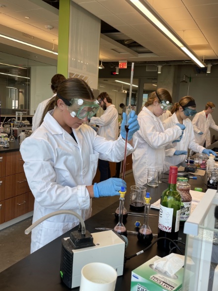 Students in lab testing wine